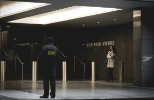 Security guard patrolling the premises at night with a flashlight, ensuring safety and surveillance